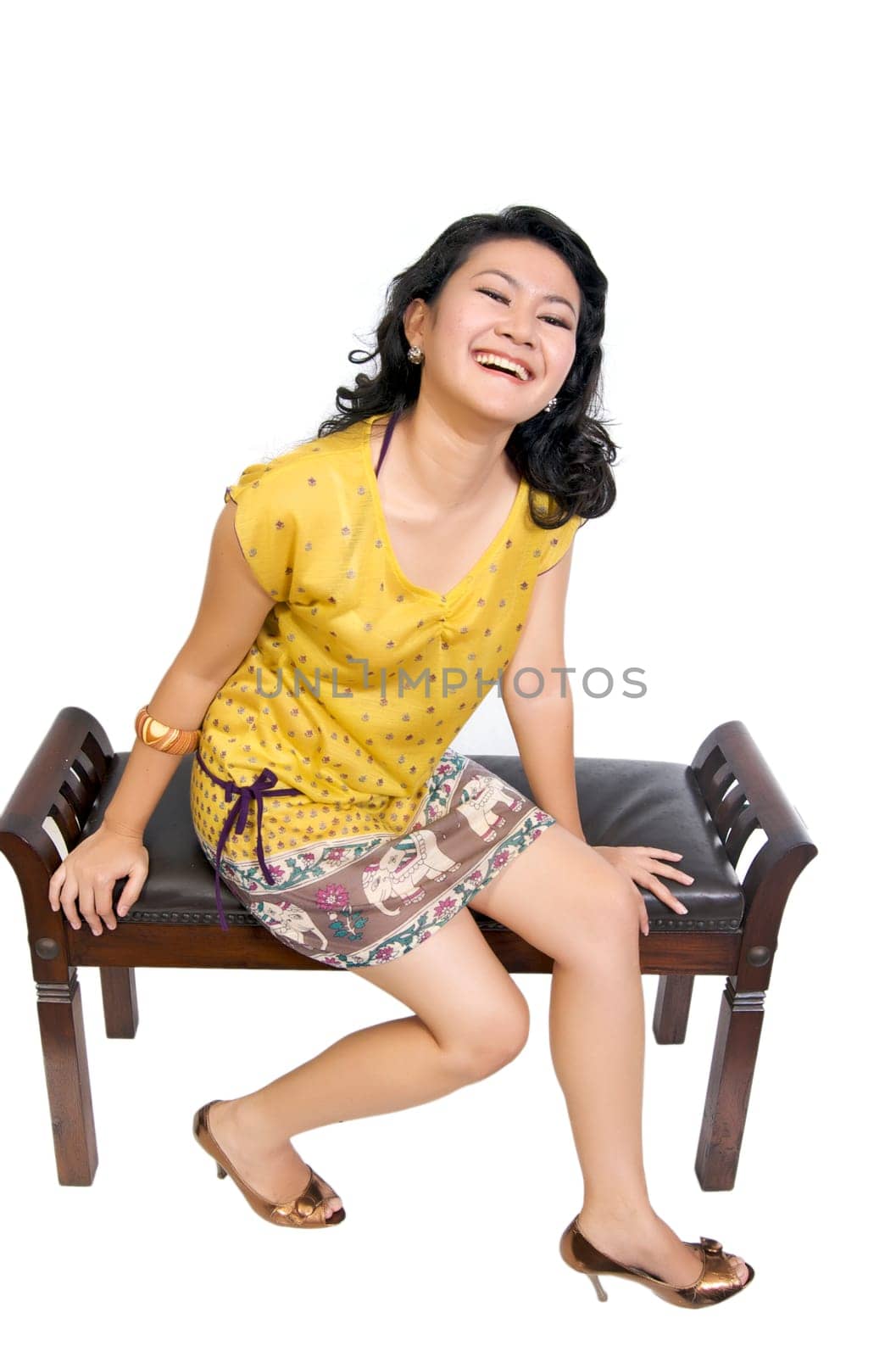Beautiful asian model sitting on chair in the studio, looking fresh