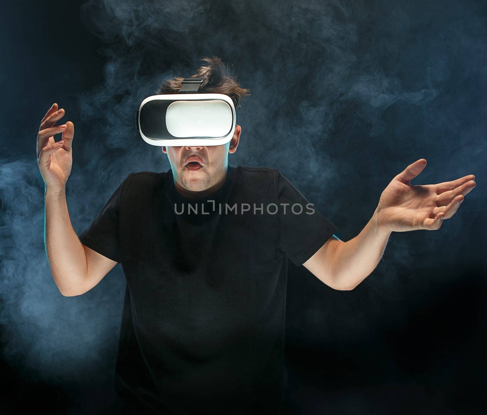The man with glasses of virtual reality. Future technology concept. Black studio smoky background