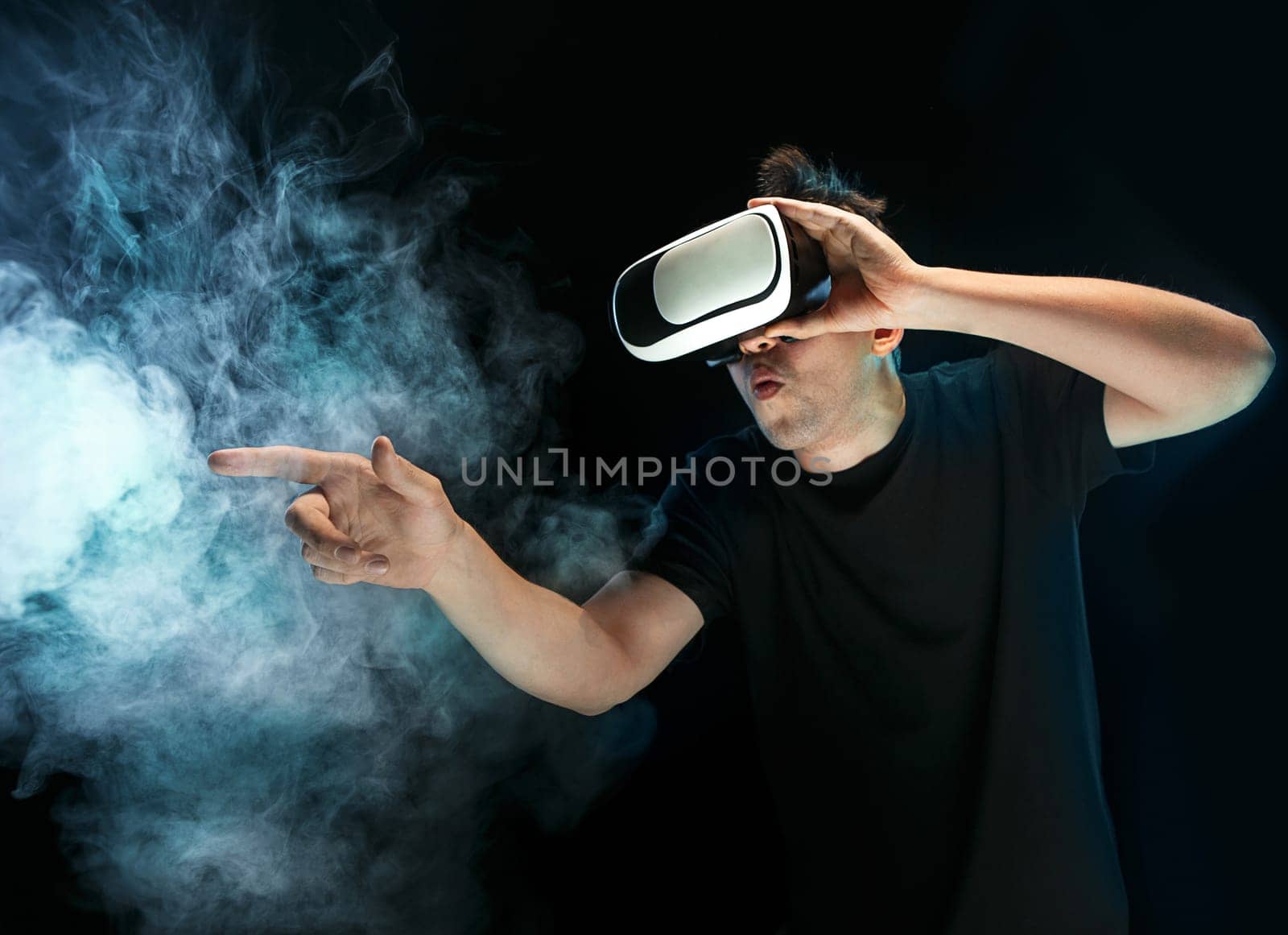 The man with glasses of virtual reality. Future technology concept. Black studio smoky background