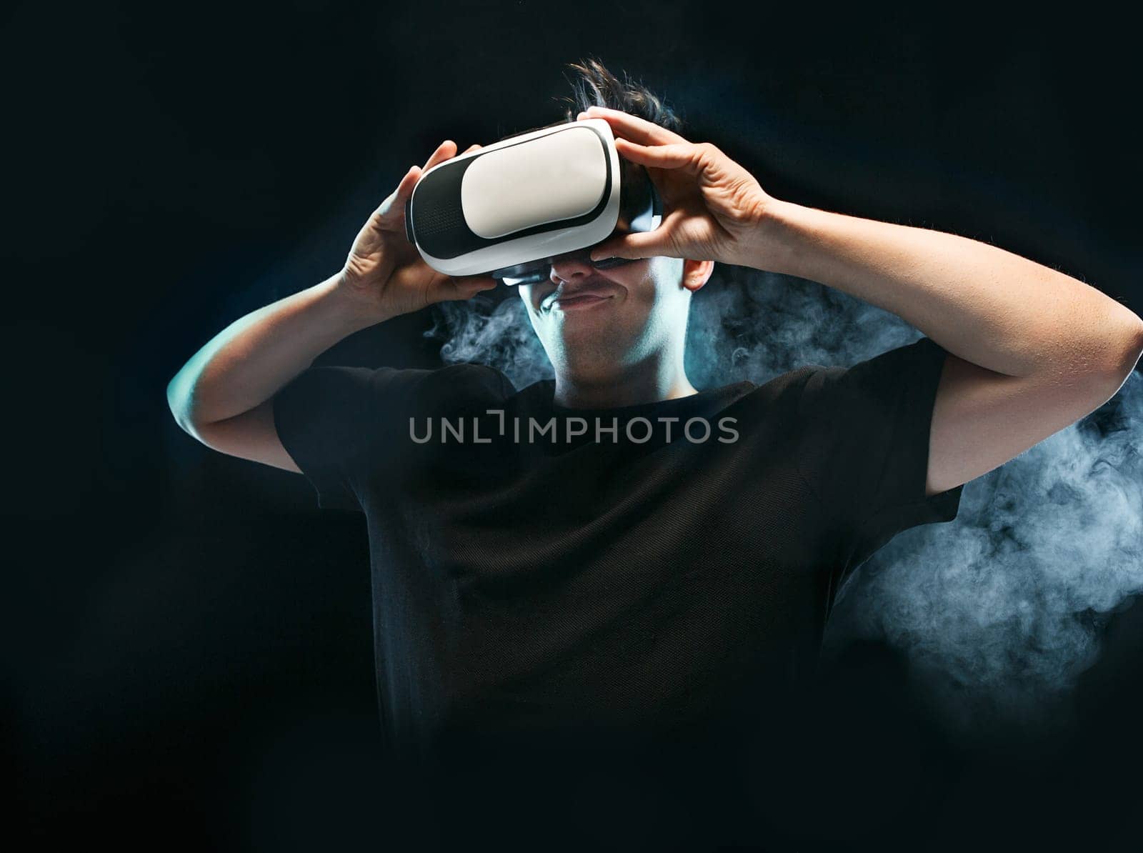 The man with glasses of virtual reality. Future technology concept. Black studio smoky background
