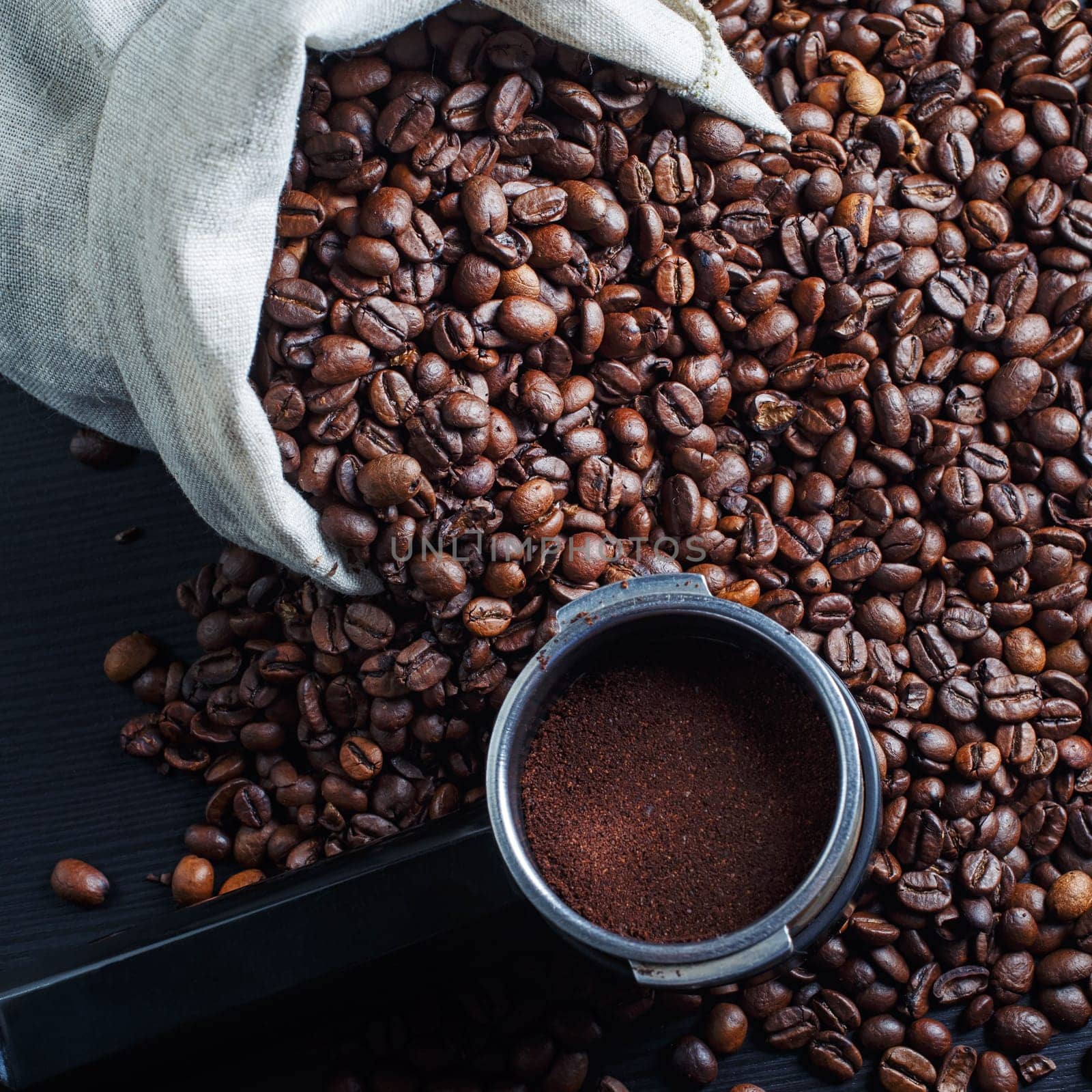 Coffee beans and holder from an espresso machine.