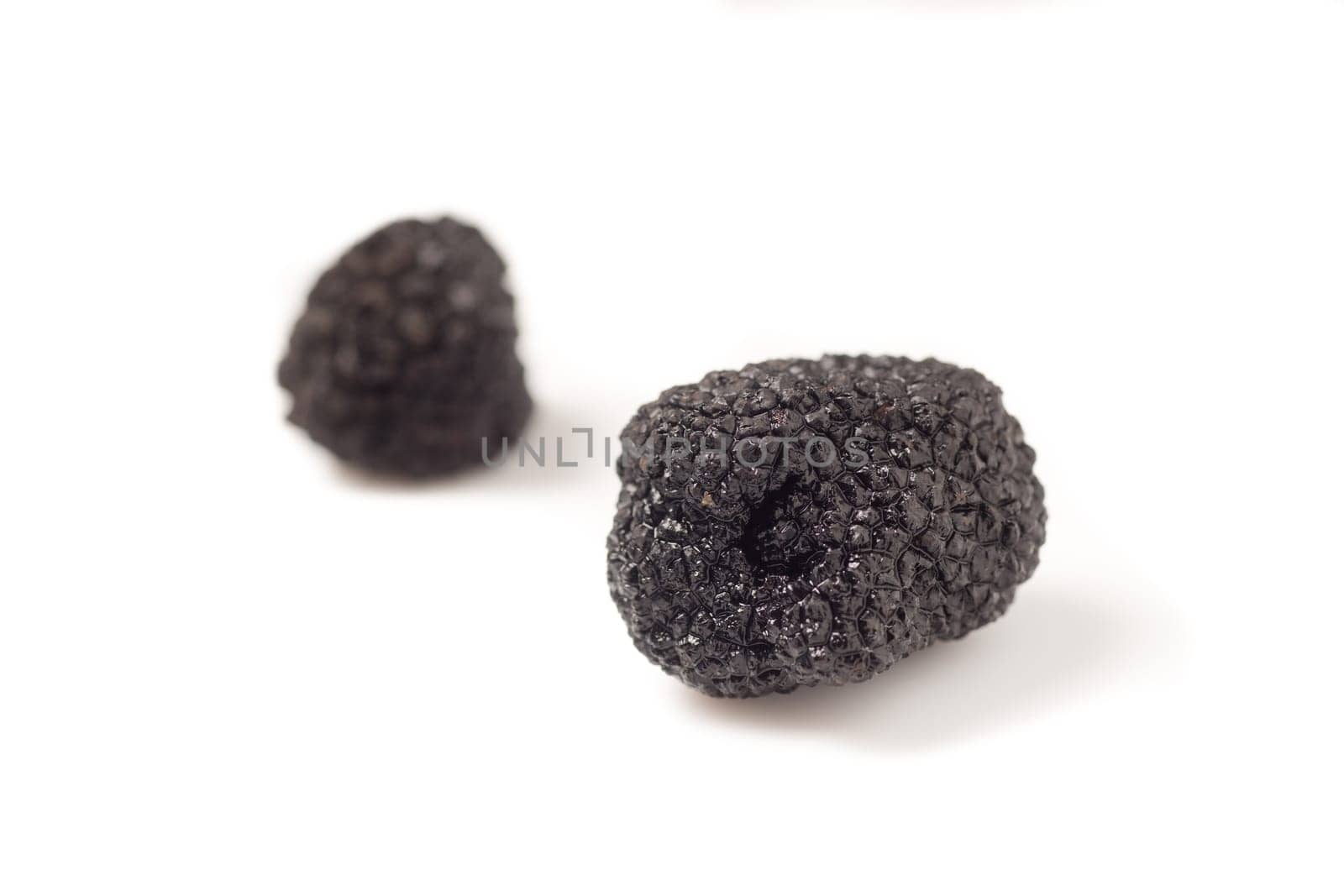 Delicate exclusive black truffles, isolated on white background