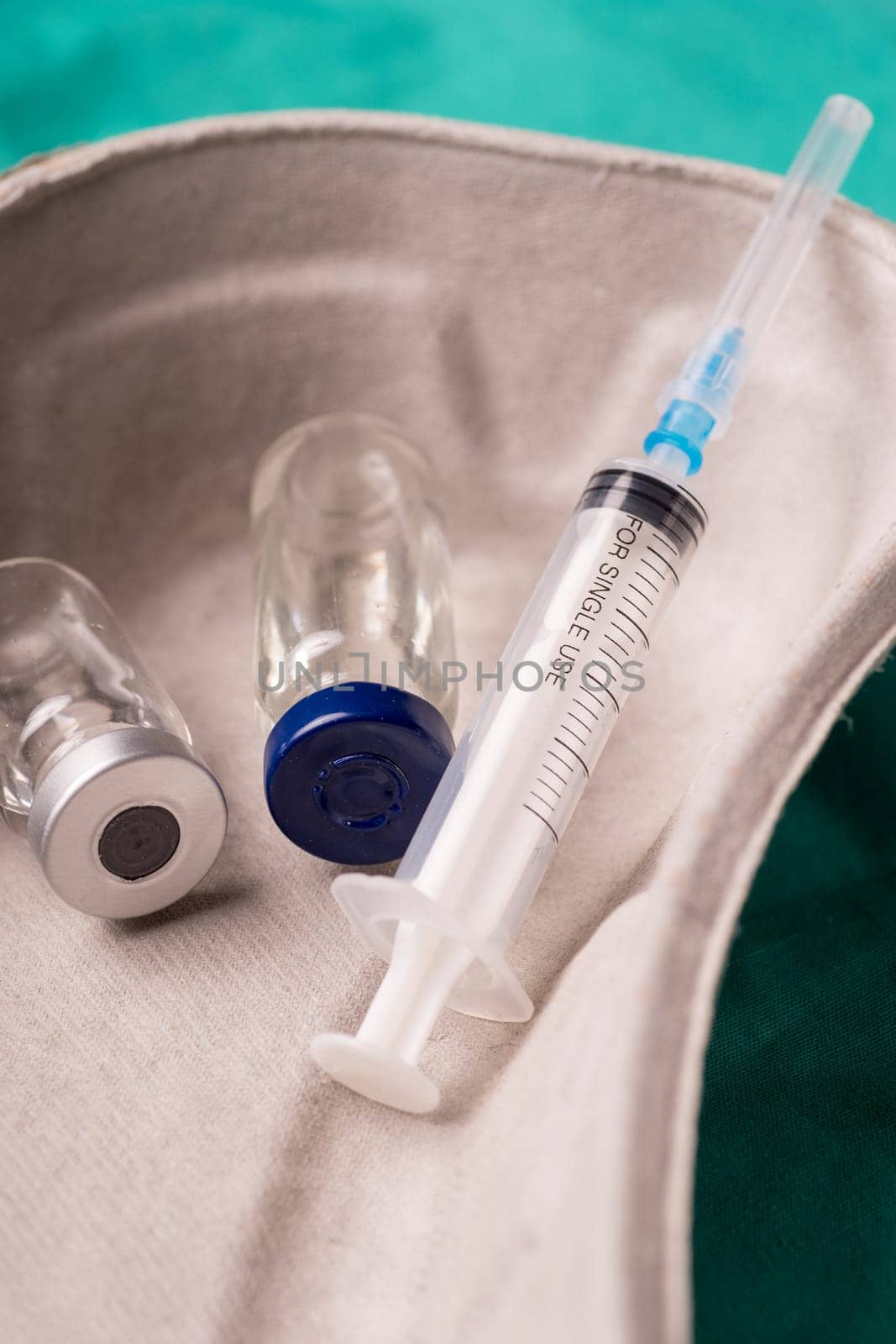 Medical Stethoscope lying on the hospital's green background. The background can be a textile part of a doctor or nurse's work uniform