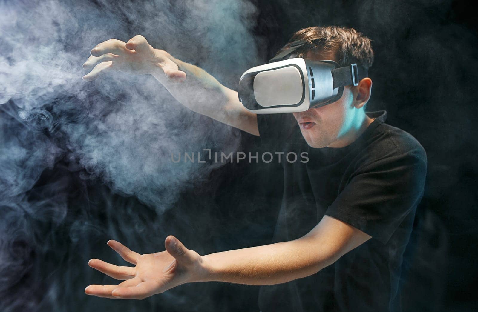 The man with glasses of virtual reality. Future technology concept. Black studio smoky background