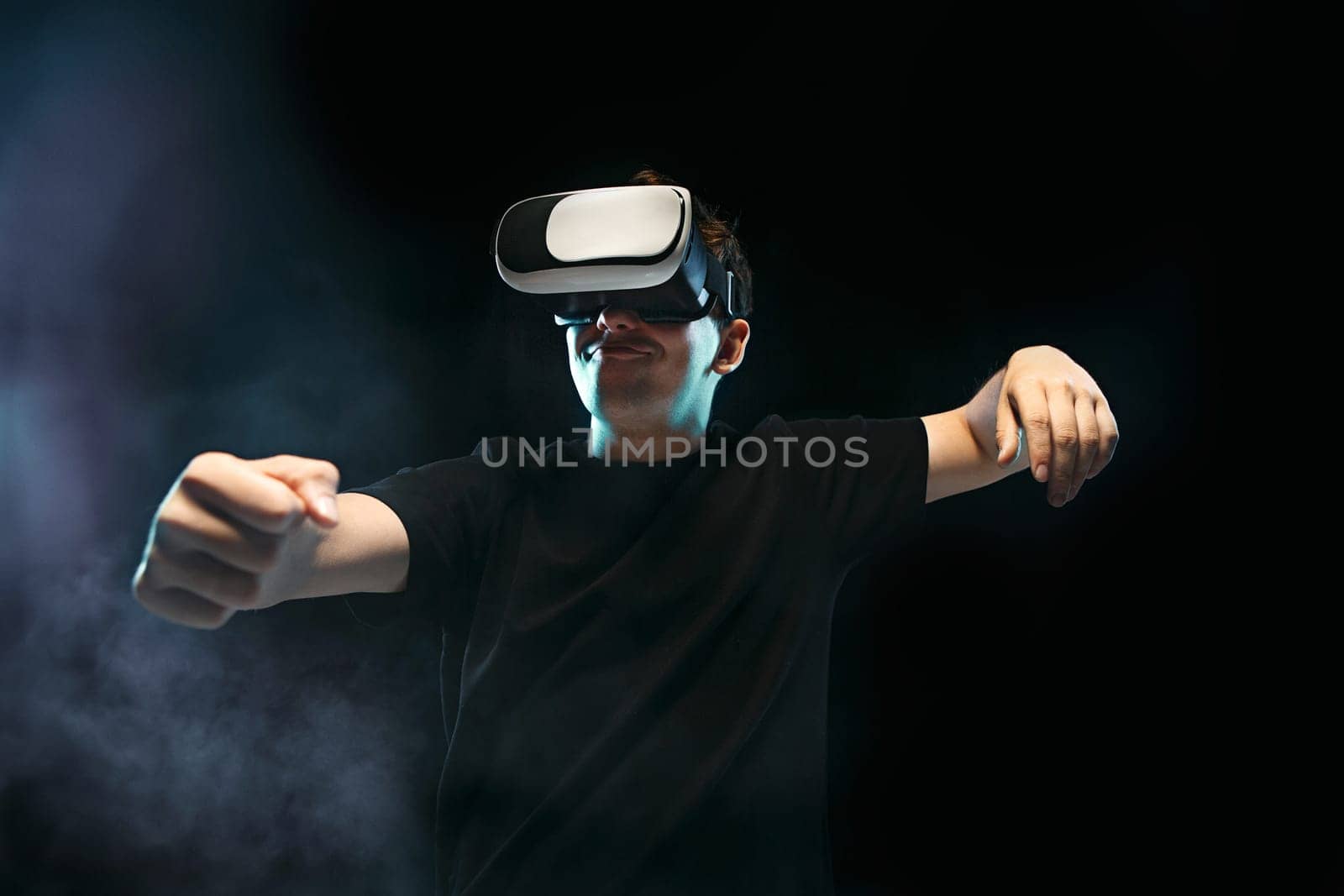 The man with glasses of virtual reality. Future technology concept. Black studio smoky background
