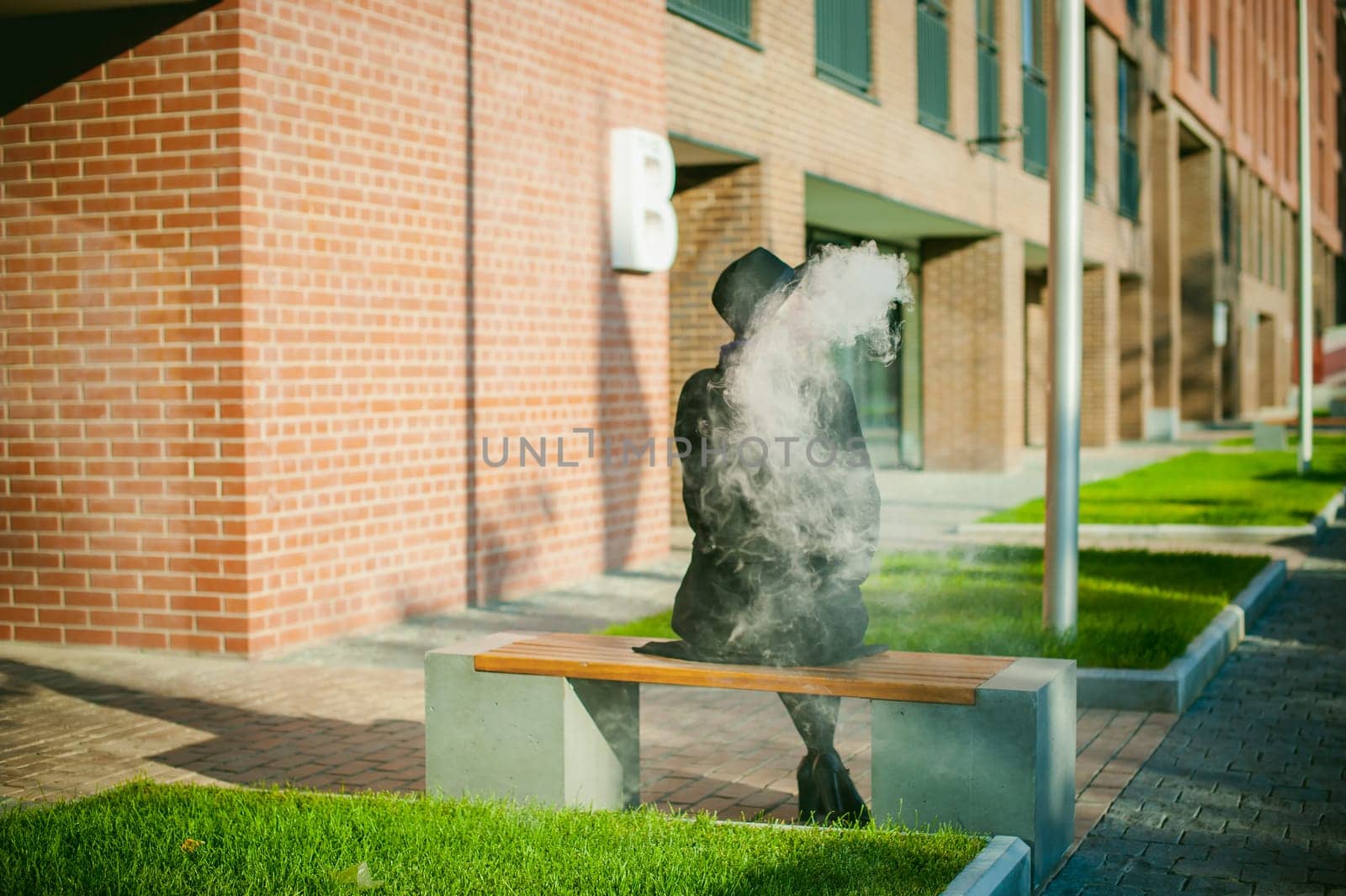 portrait of young beautiful woman with white hair, in a black coat, a skirt and a black hat, smoking an electronic cigarette, blowing the smoke vapor
