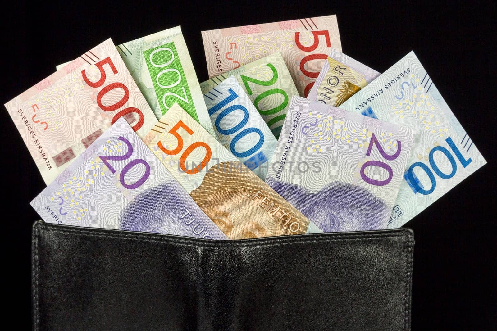 Wallet with Swedish Krona Currency on black background.