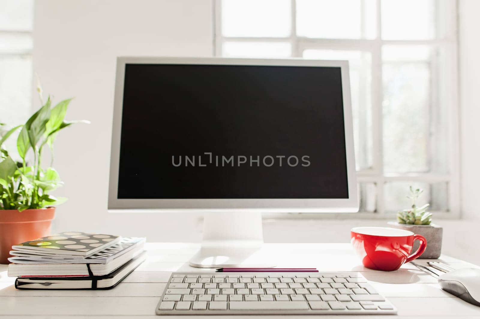 Stylish white workspace with computer on home or studio