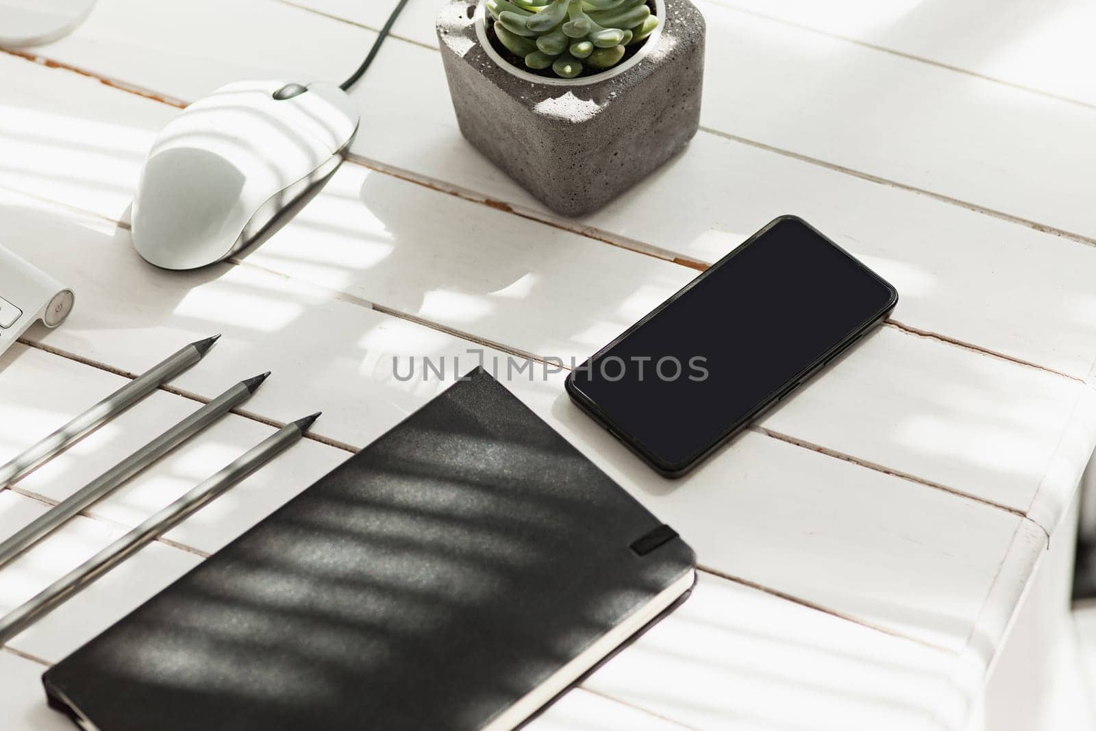 Office desk table with computer, supplies and mobile phone