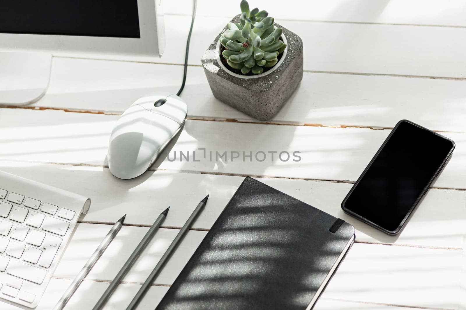 Office desk table with computer, supplies and mobile phone
