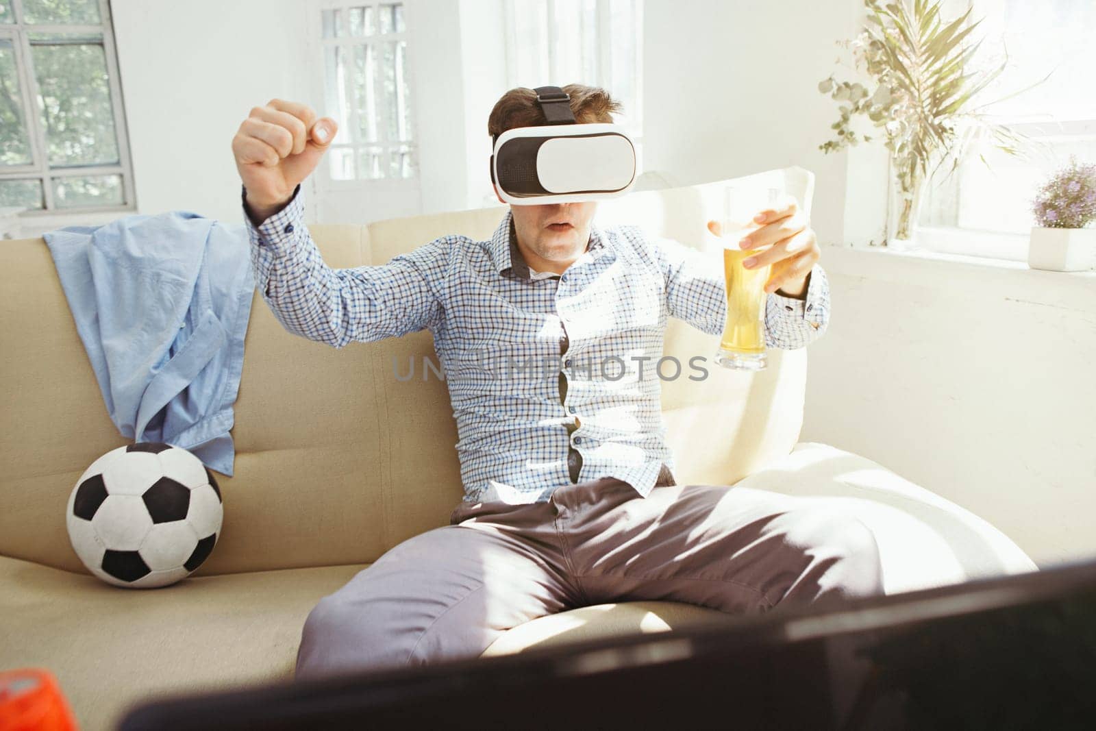 The man with glasses of virtual reality at home. Future technology concept.