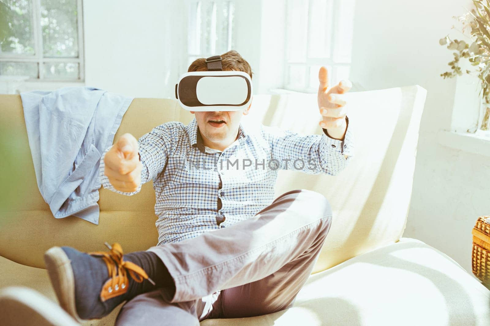 The man with glasses of virtual reality at home. Future technology concept.