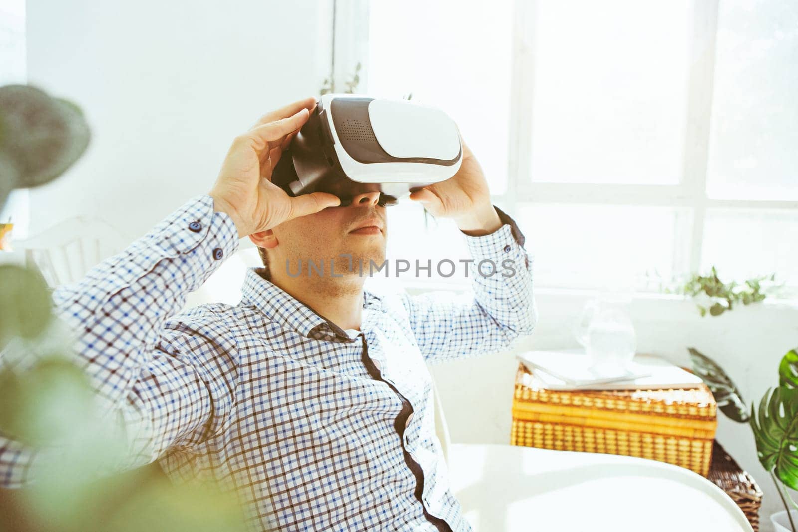 The man with glasses of virtual reality at home. Future technology concept.