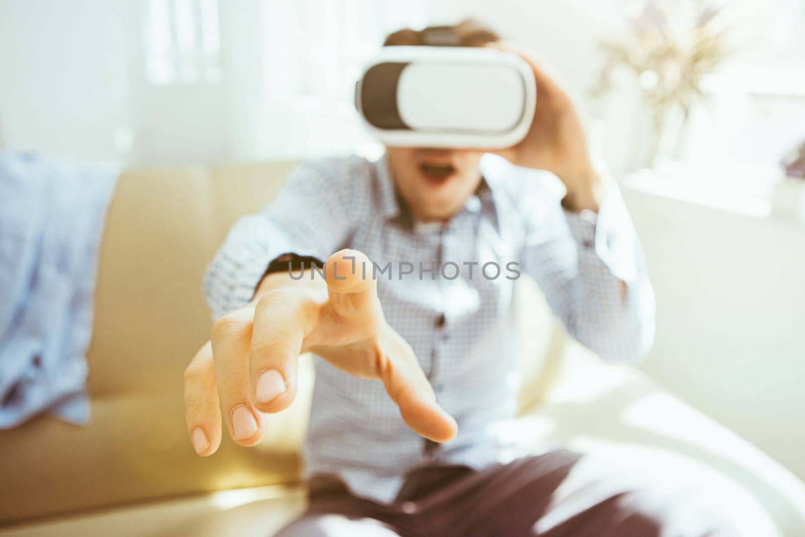 The man with glasses of virtual reality at home. Future technology concept.