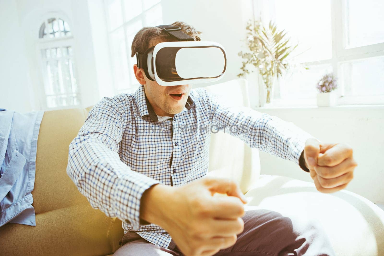 The man with glasses of virtual reality at home. Future technology concept.