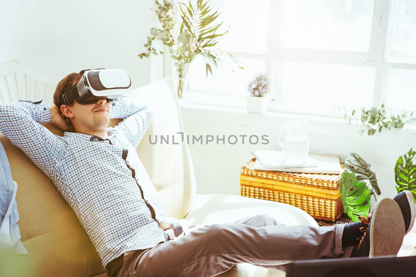 The man with glasses of virtual reality at home. Future technology concept.