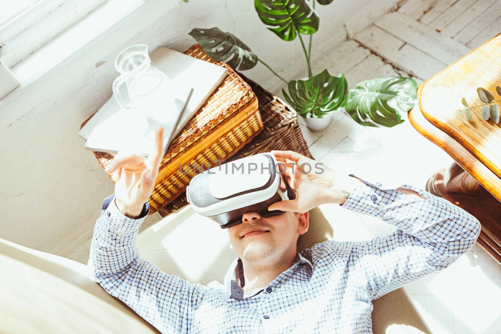 The man with glasses of virtual reality at home. Future technology concept.