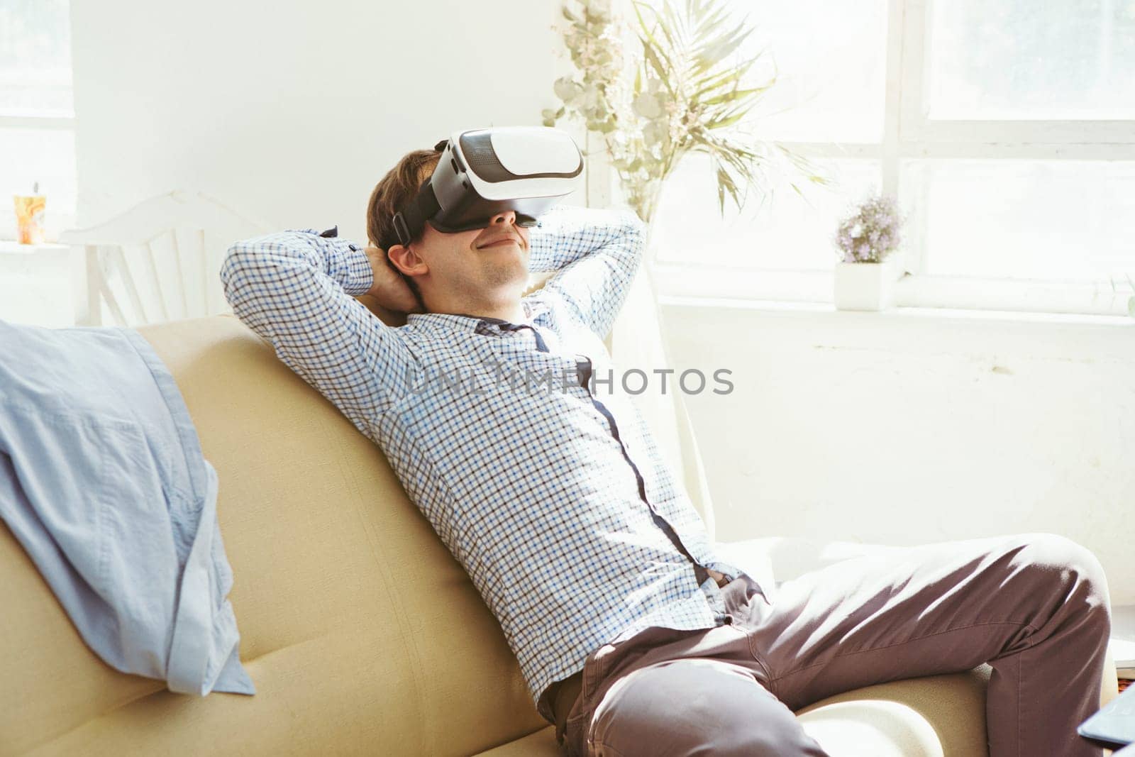 The man with glasses of virtual reality at home. Future technology concept.