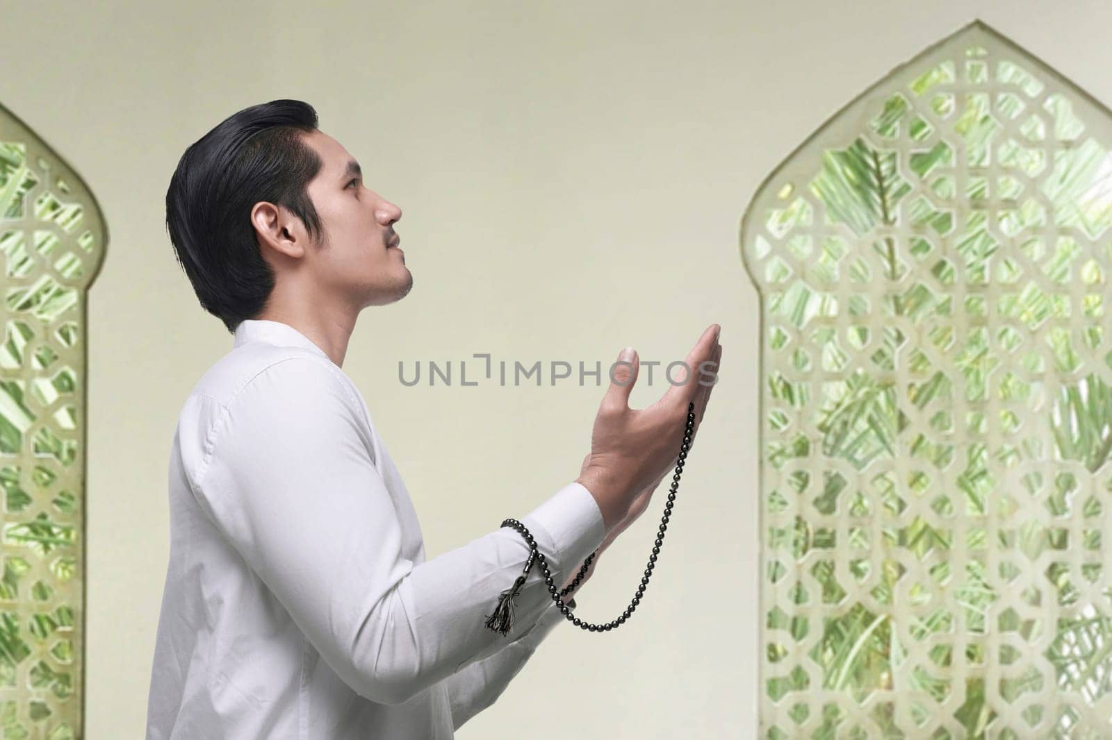 Portrait of asian muslim man praying to god on the mosque