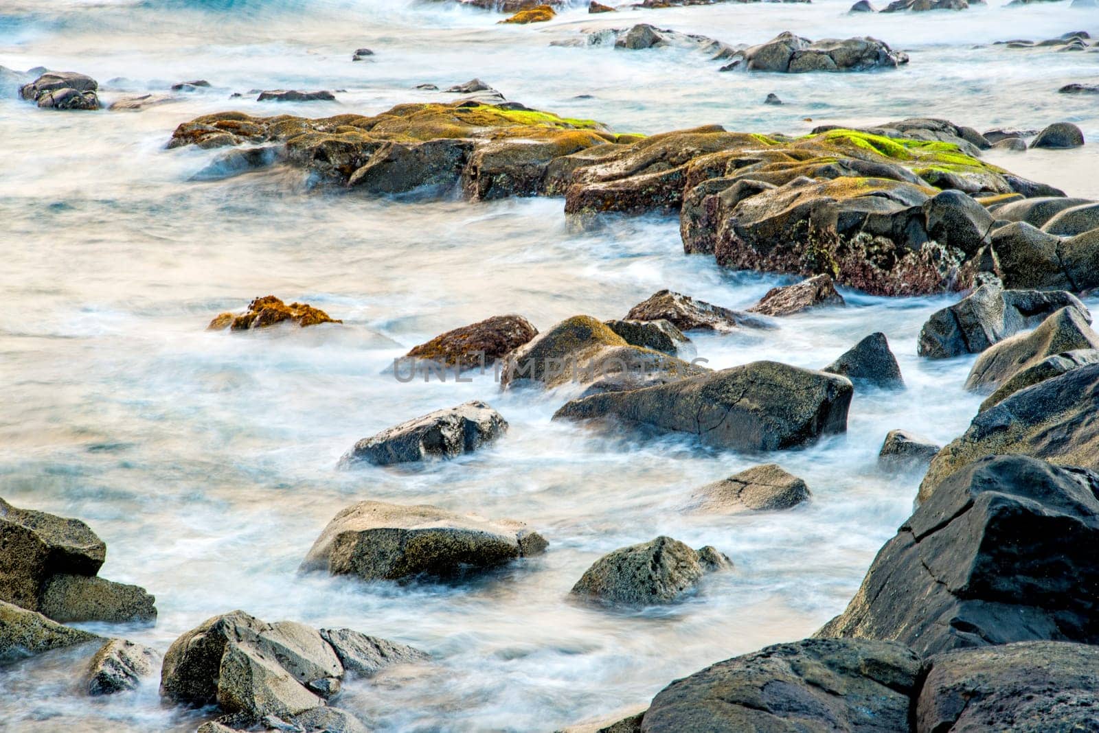 Surf of the Atlantic Ocean with rocks in long exposure