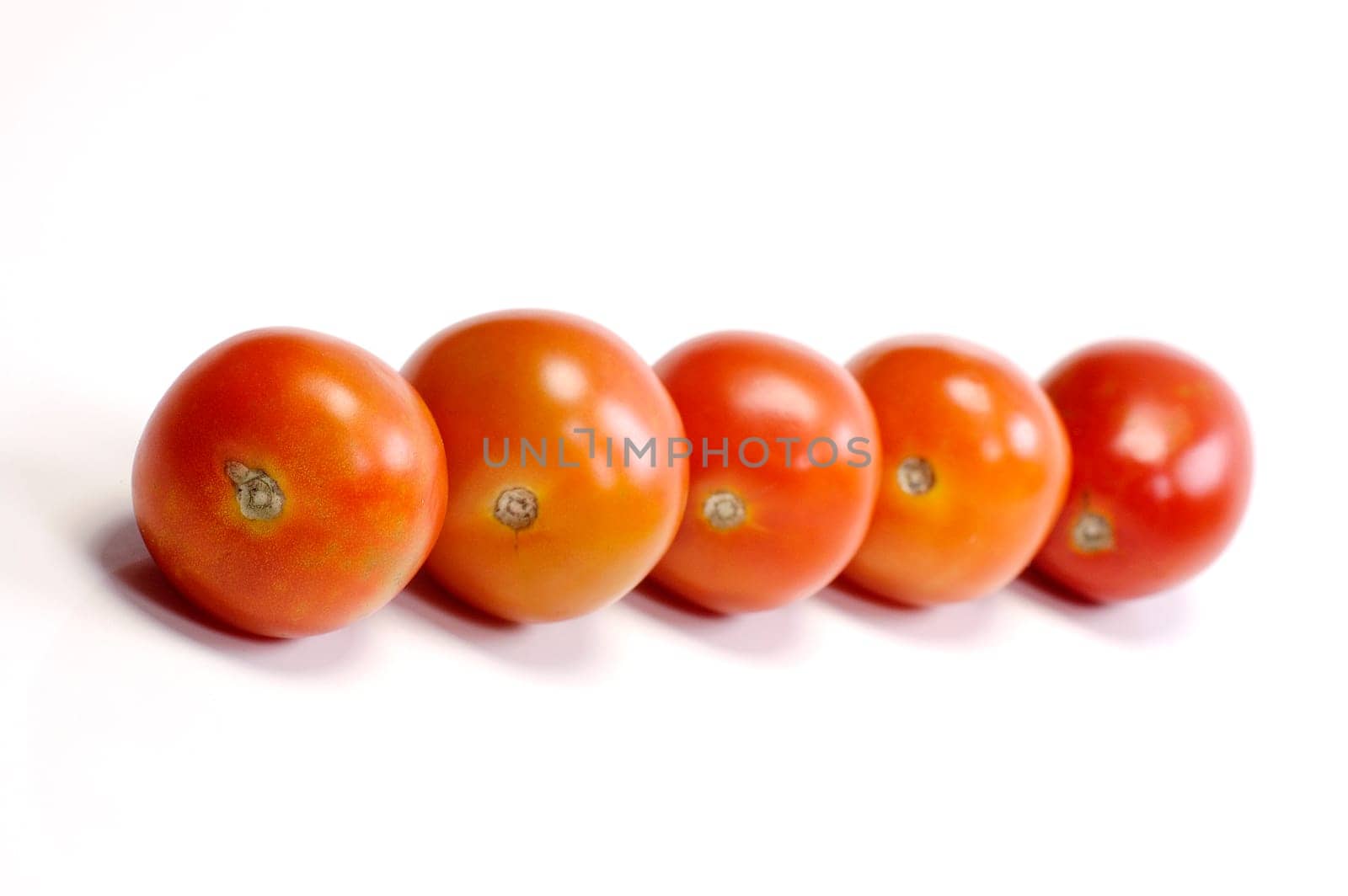 Five tomatoes on white background. Look tasty and fresh