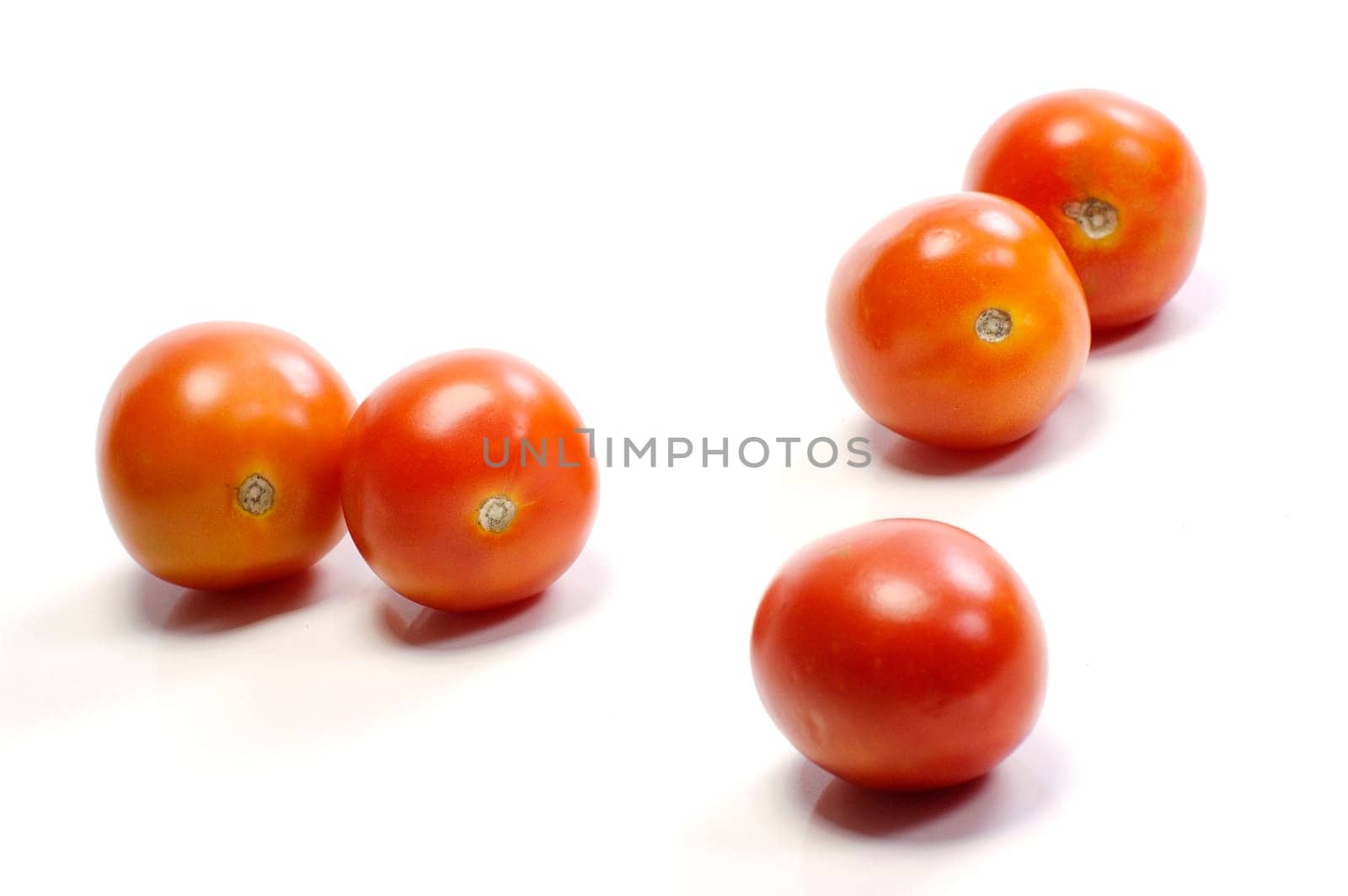 Five tomatoes on white background. Look tasty and fresh