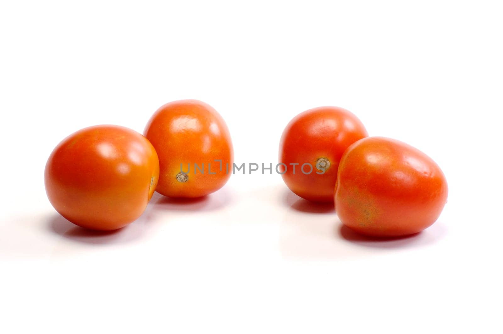 Four tomatoes on white background. Look tasty and fresh