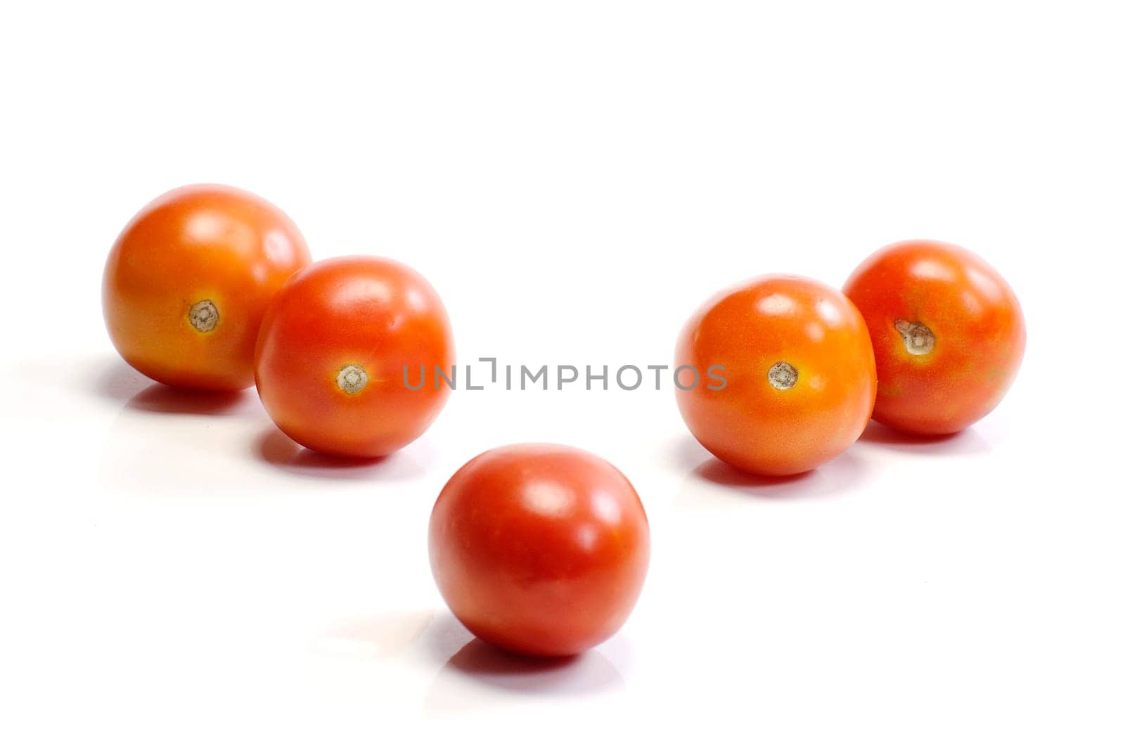 Five tomatoes on white background. Look tasty and fresh