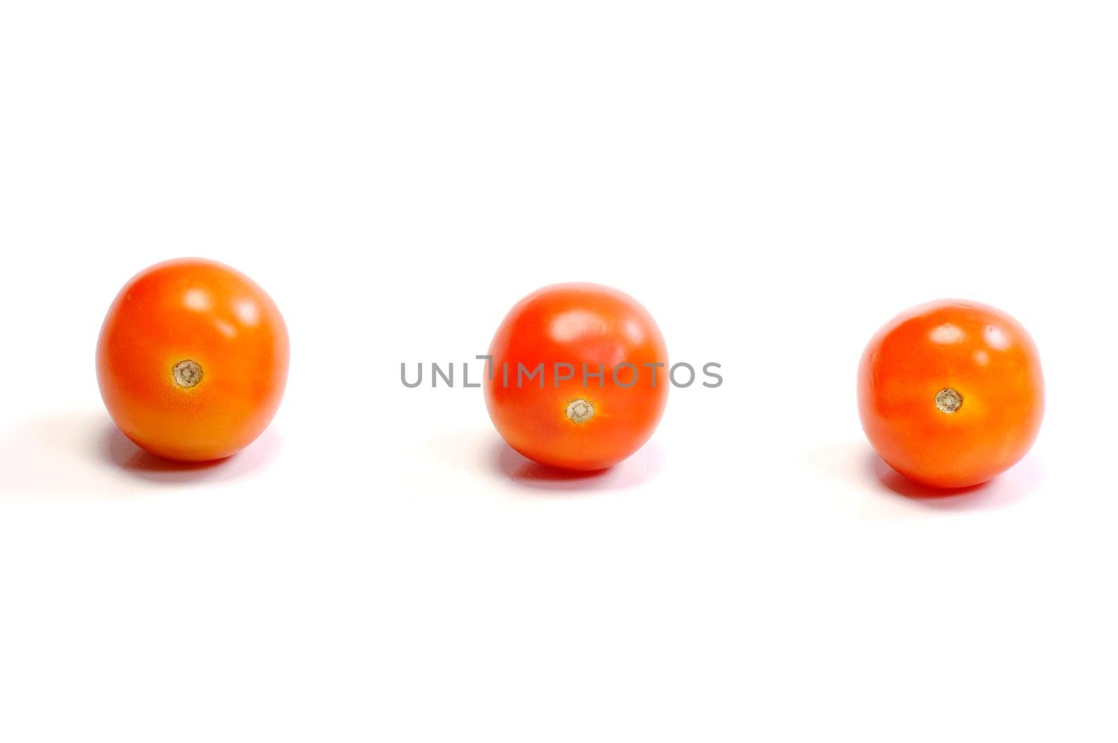 Three tomatoes on white background. Look tasty and fresh