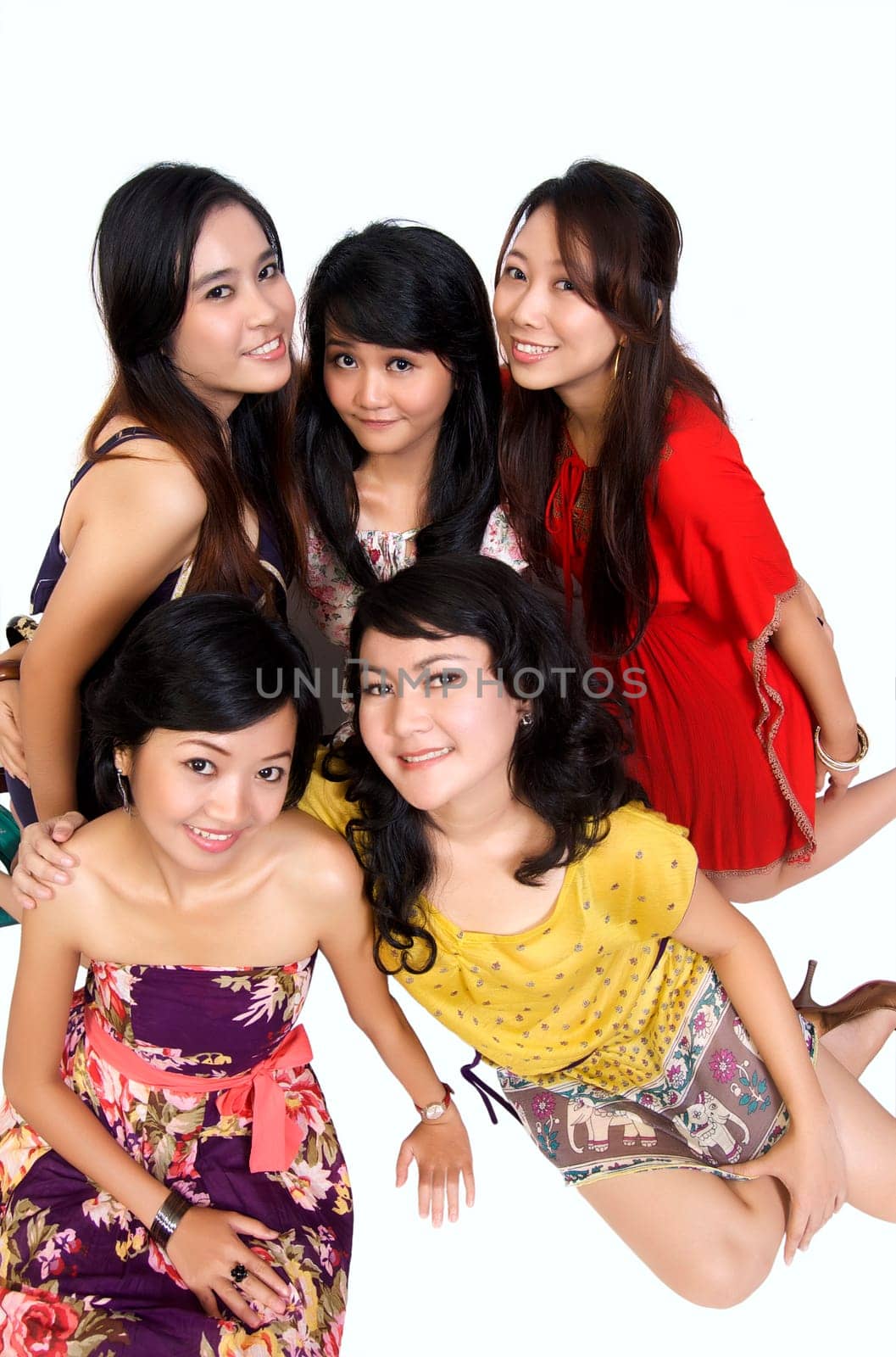 Happy group of attractive young women smiling isolated on white background
