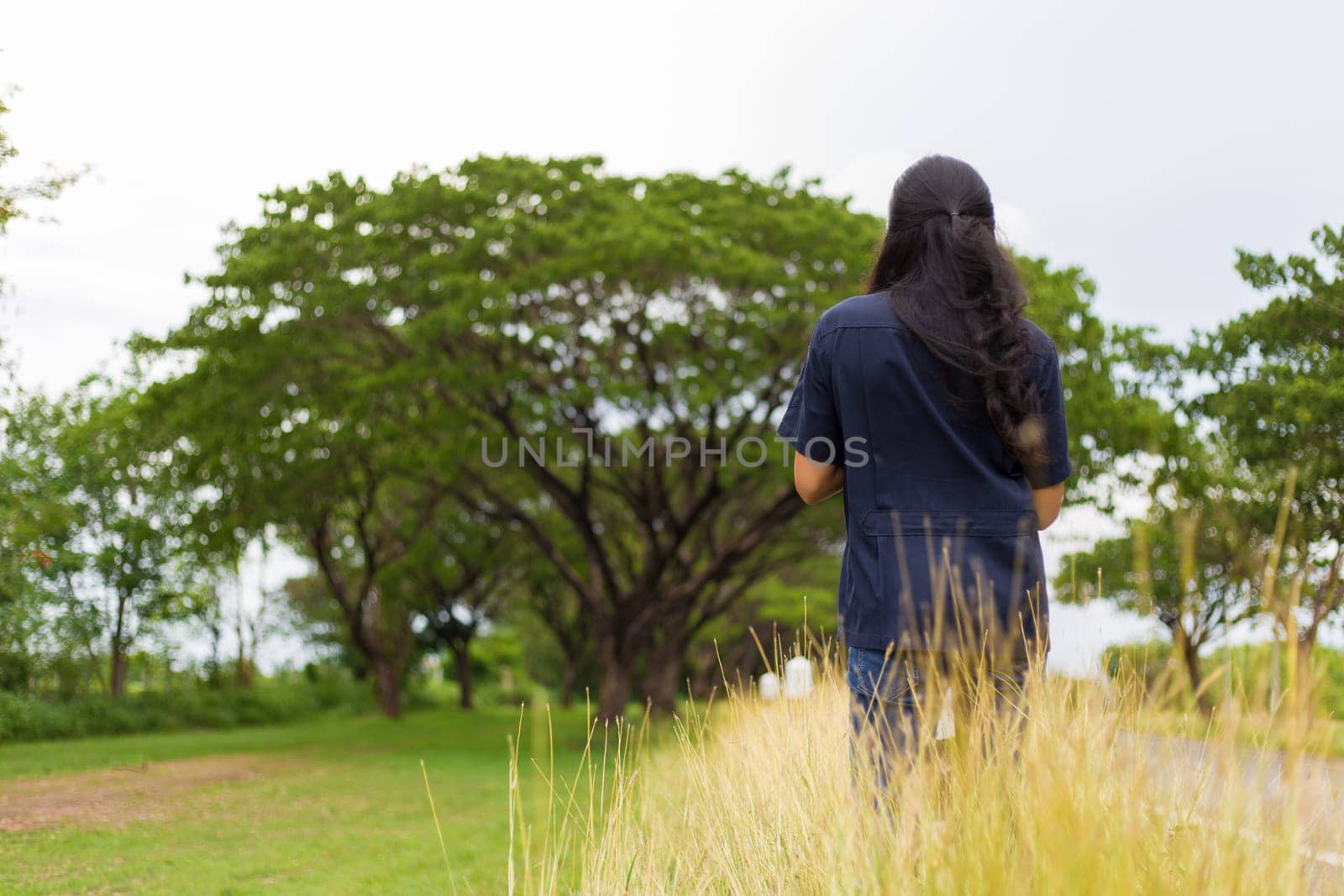 Beautiful young Asian woman standing near the road