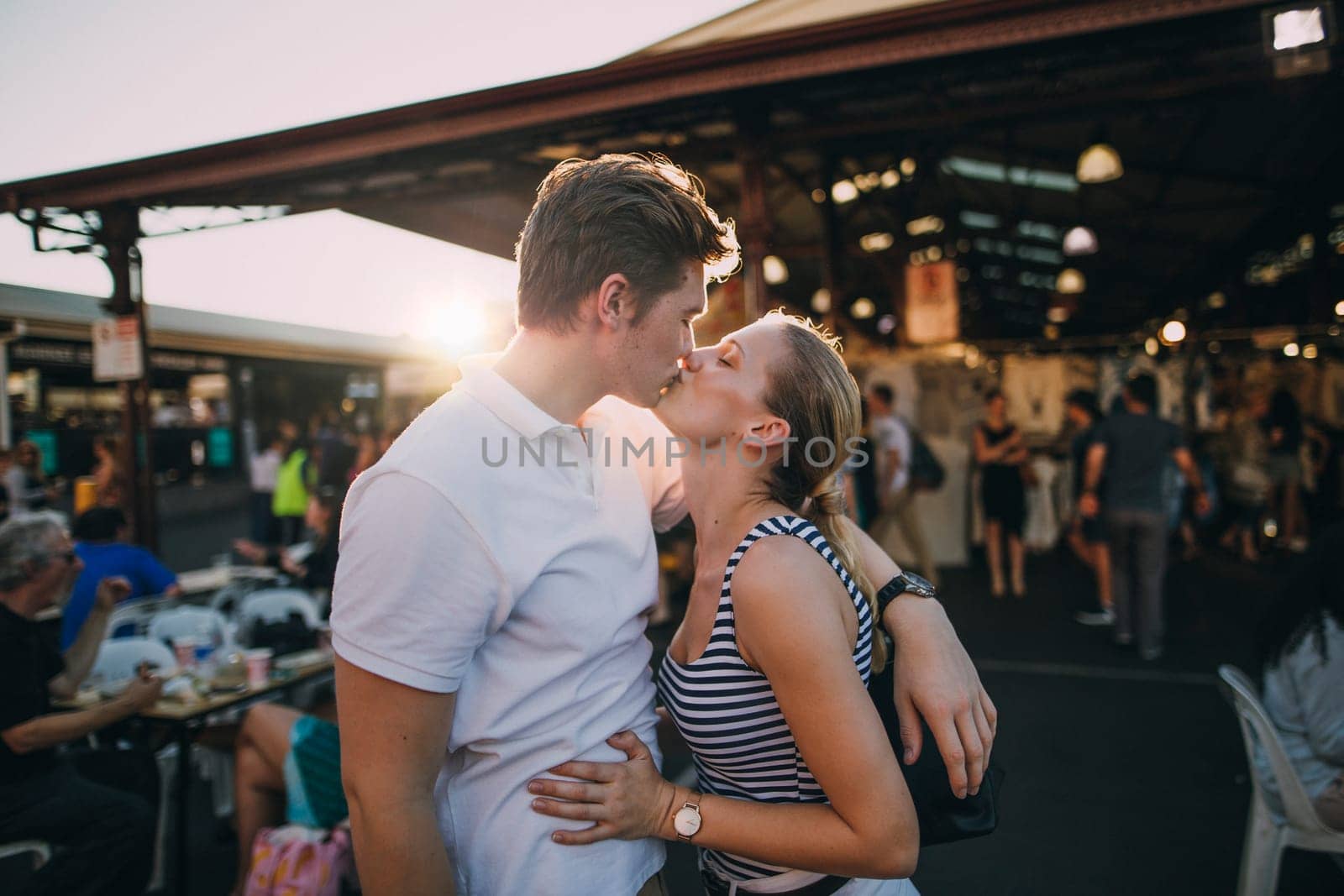 Happy couple kissing in Queen Victoria Market, Australia.