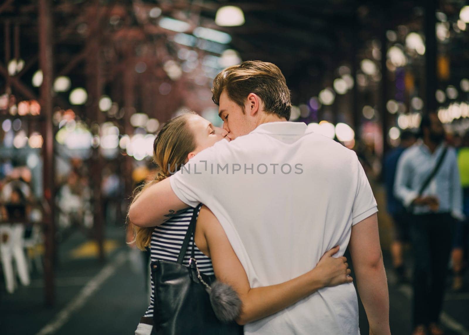 Happy couple kissing in Queen Victoria Market, Australia.