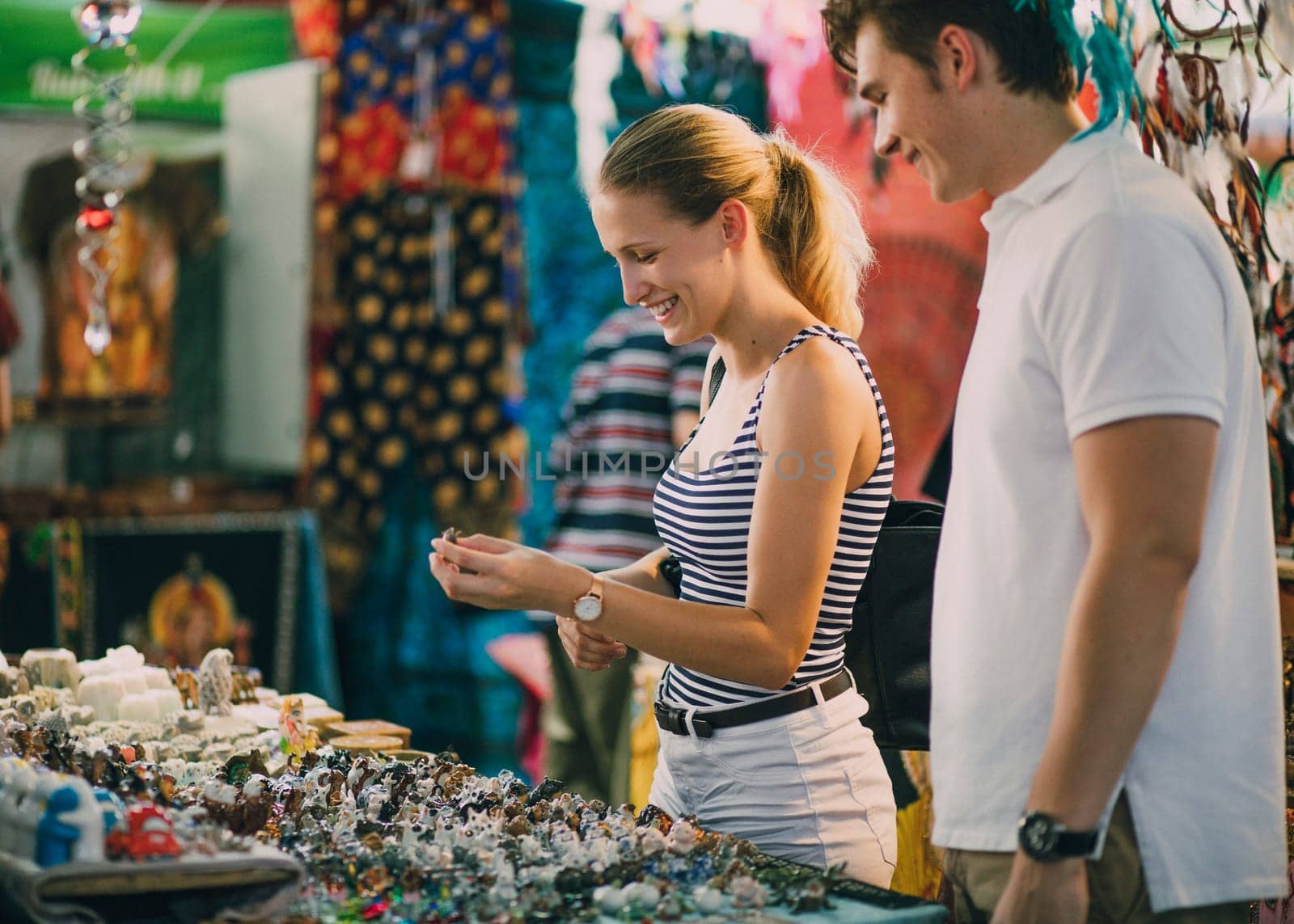 Young couple are looking at a jewellery stall in Queen Victoria Market, Australia.