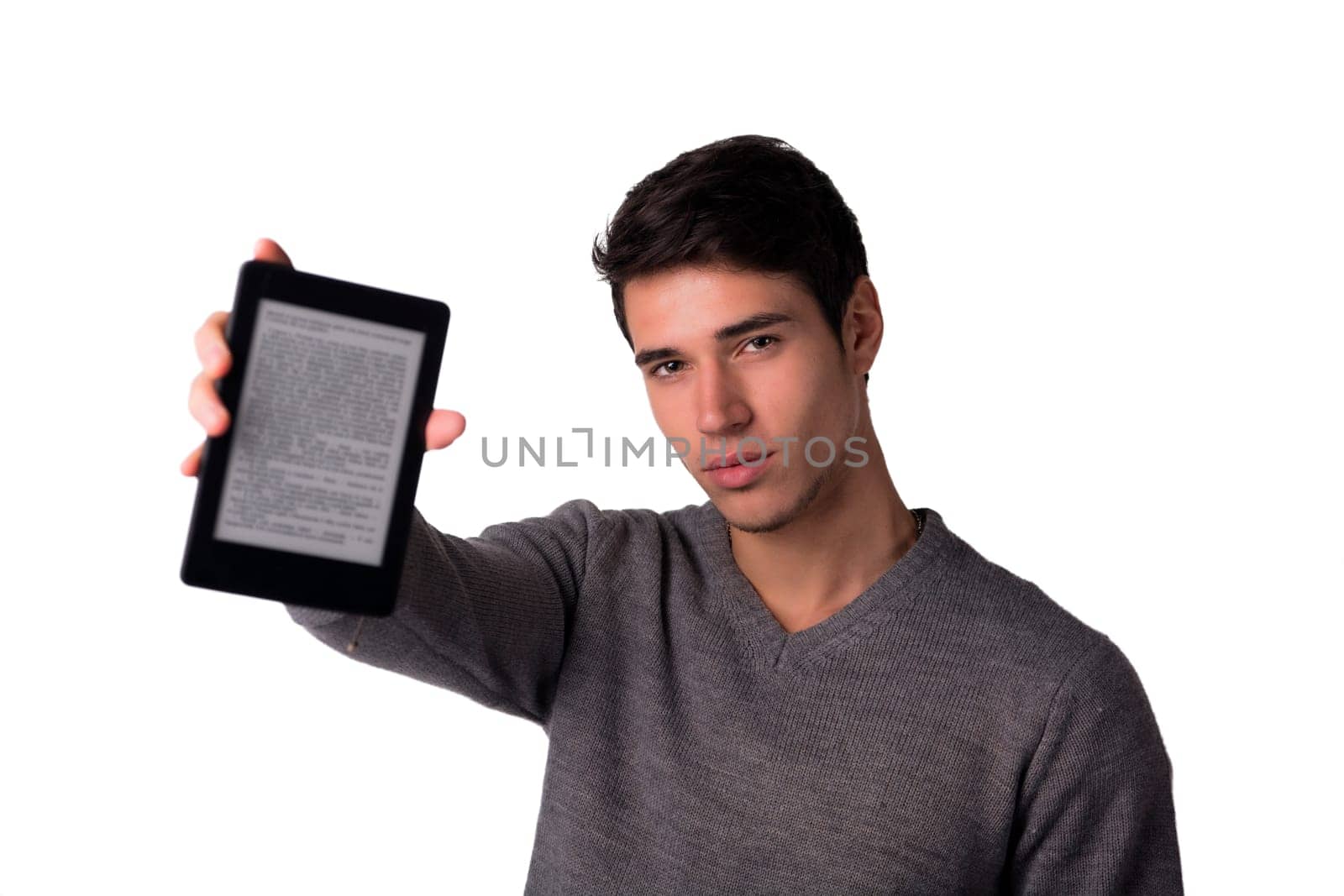 Handsome young man holding ebook reader and looking at camera, isolated on white background