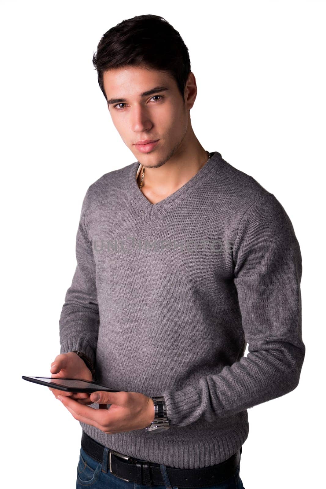 Handsome young man holding ebook reader and looking at camera, standing isolated on white background