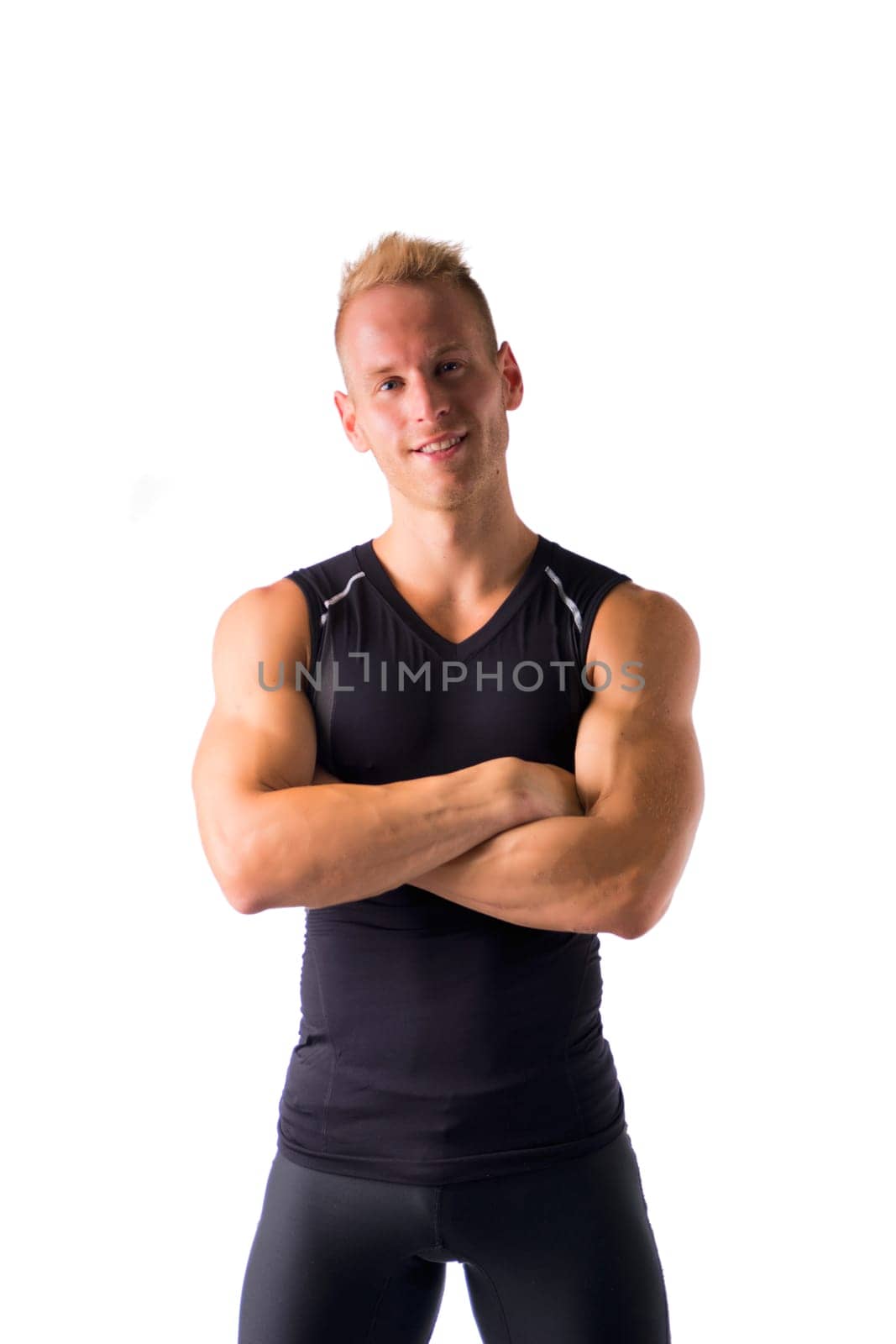 Muscular male model smiling, posing with a lot of confidence, arms crossed on his chest, isolated on white