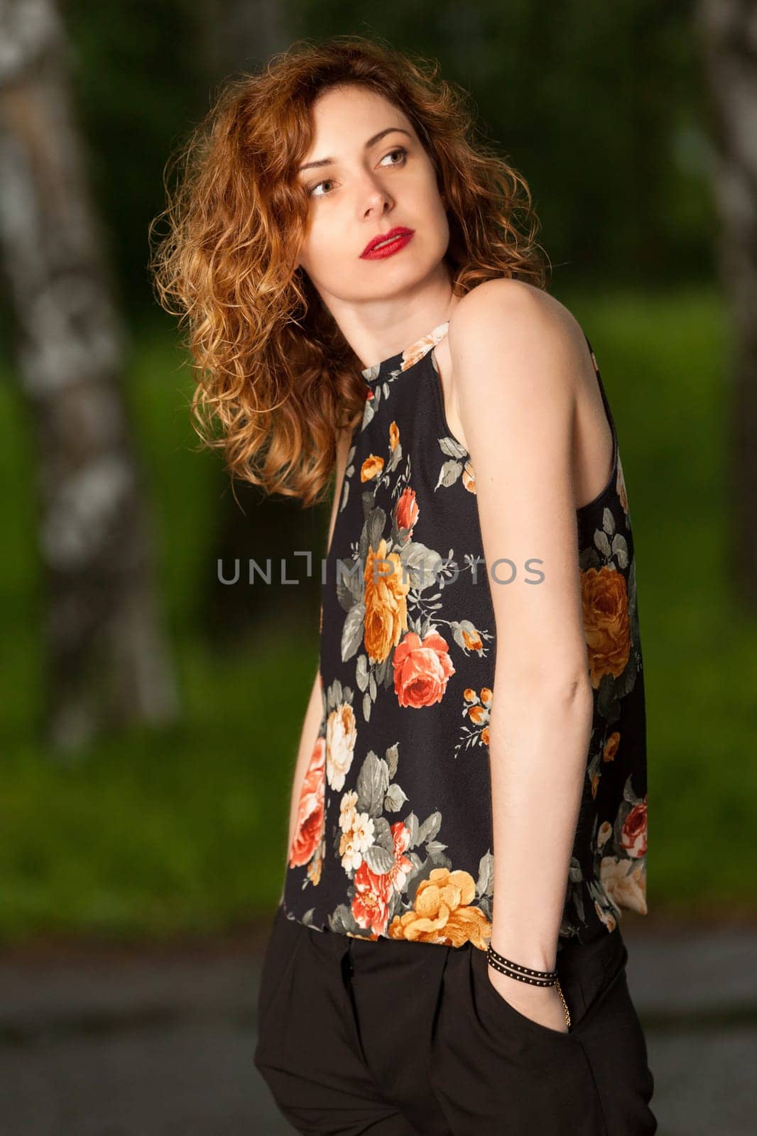 Young attractive woman after rain in nature