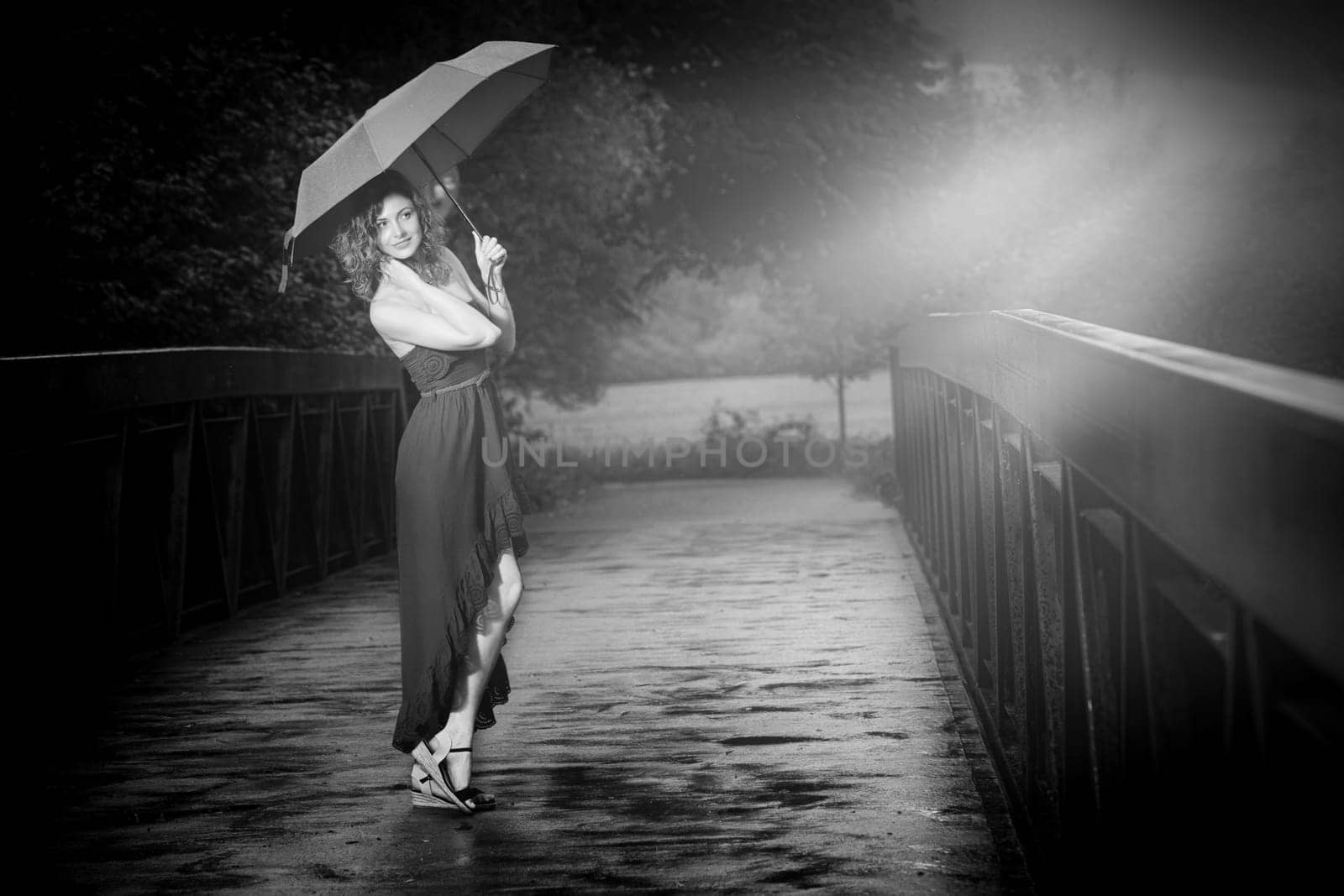 Young attractive woman with red umbrella after rain in nature
