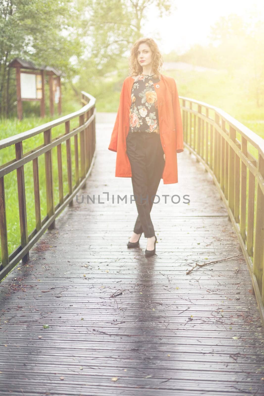 Young attractive woman after rain in nature
