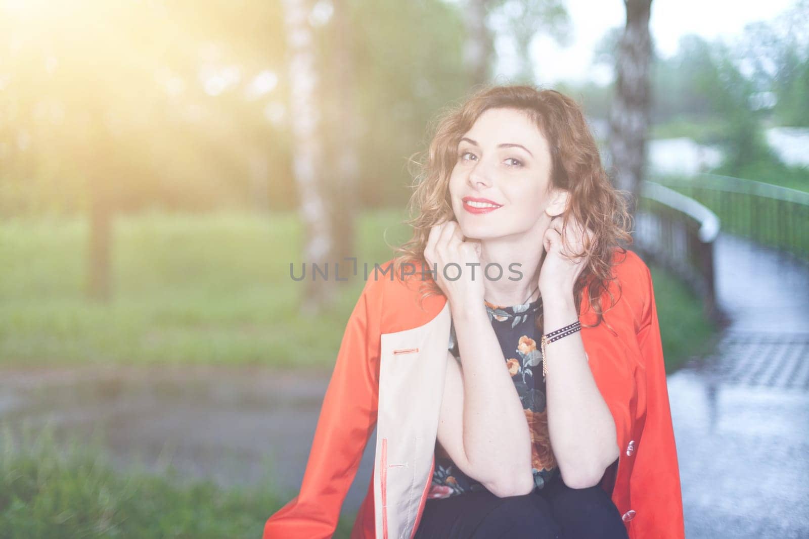 Young attractive woman after rain in nature