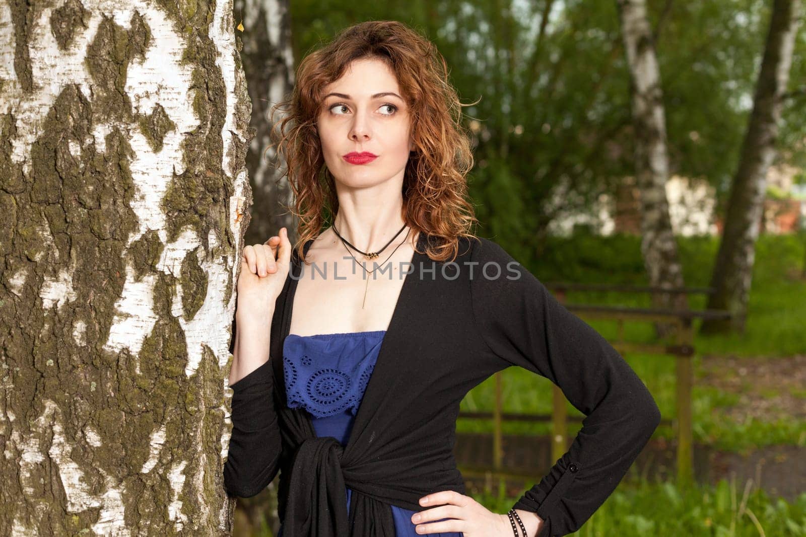 Young attractive woman after rain in nature