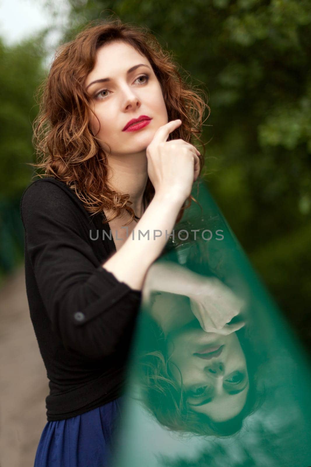 Young attractive woman after rain in nature
