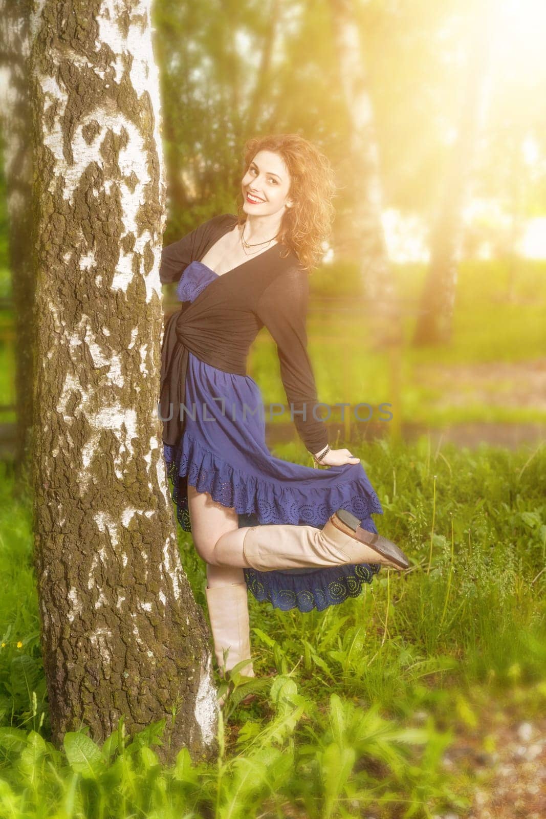 Young attractive woman after rain in nature