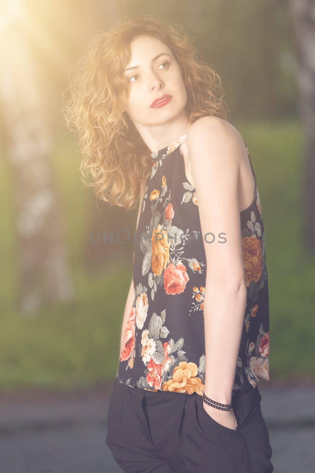 Young attractive woman after rain in nature