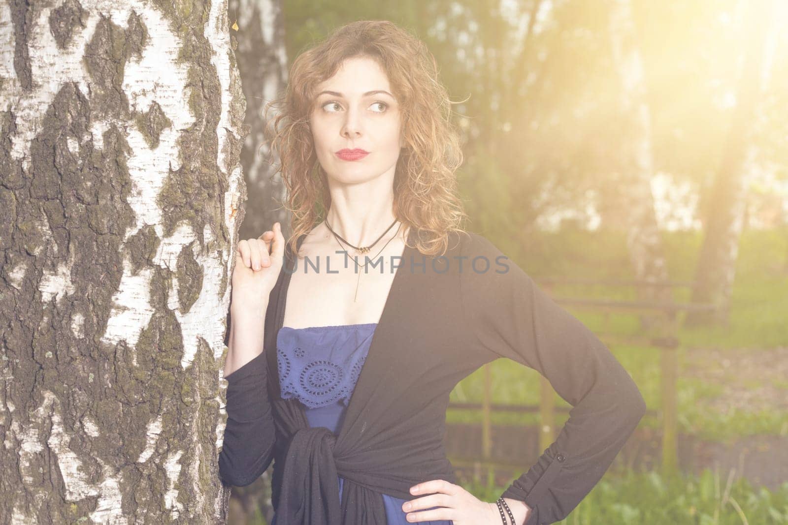 Young attractive woman after rain in nature