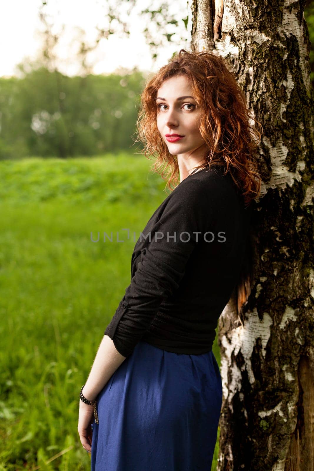 Young attractive woman after rain in nature