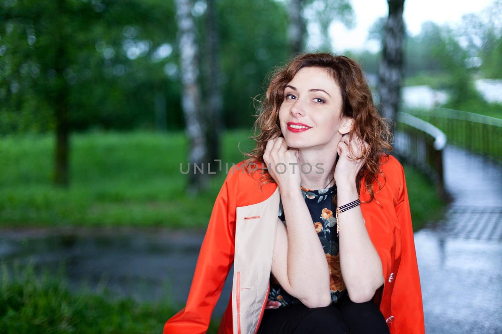 Young attractive woman after rain in nature