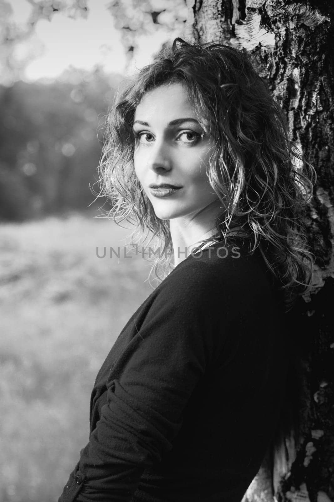 Young attractive woman after rain in nature