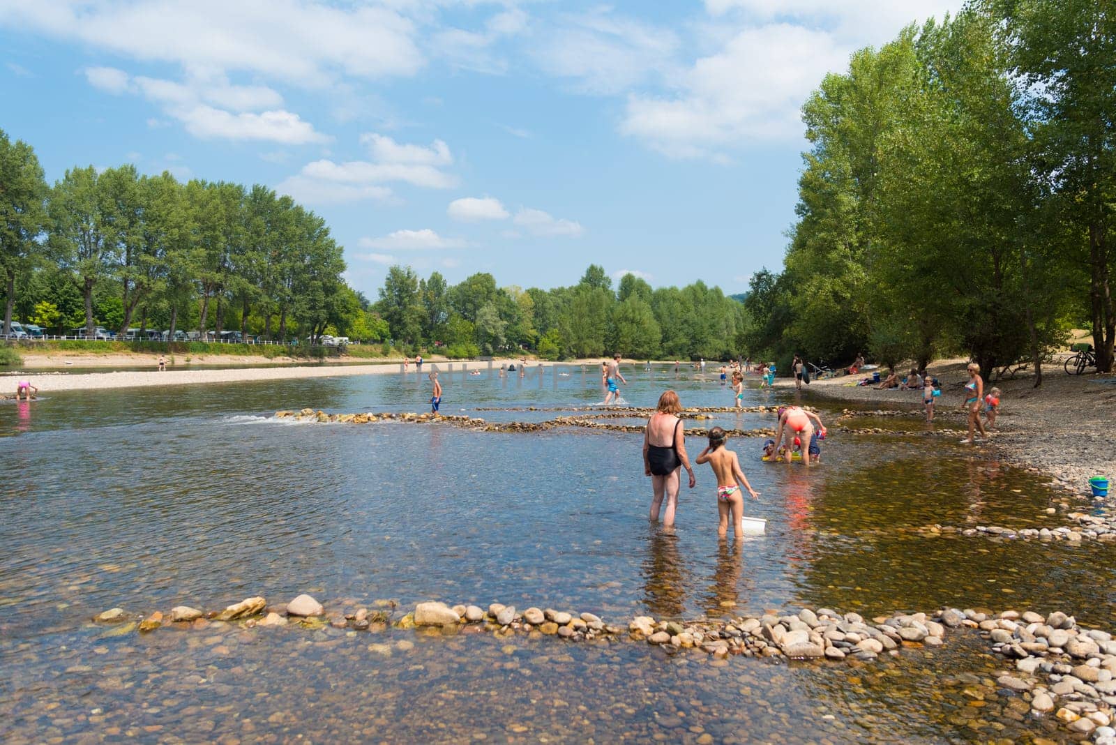 ROUFFILLAC, FRANCE - AUGIST 17, 2016: Unknown tourists enjoying the cooling water of the Dordogne river during a hot summer day